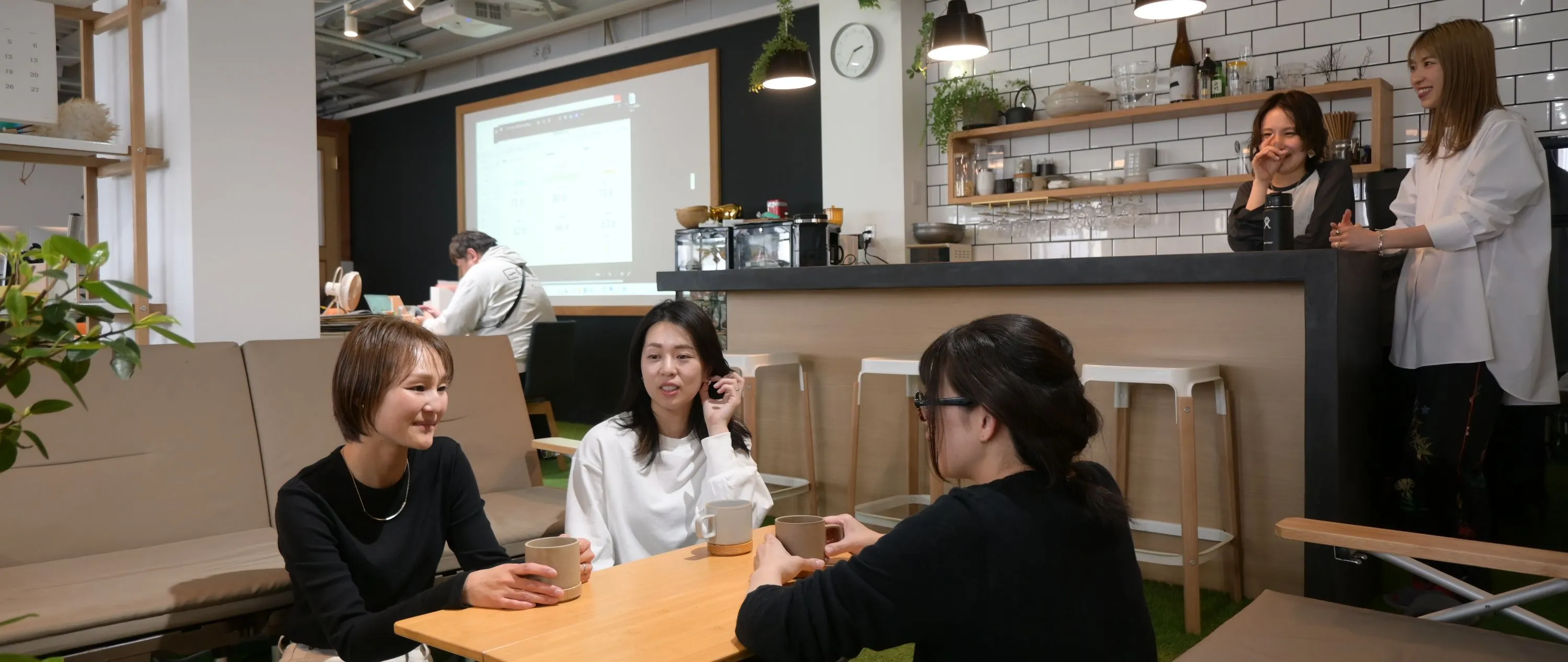 岡崎市、豊橋市の保険代理店、株式会社クワイエットの社内で保険事務スタッフが談笑をしている様子